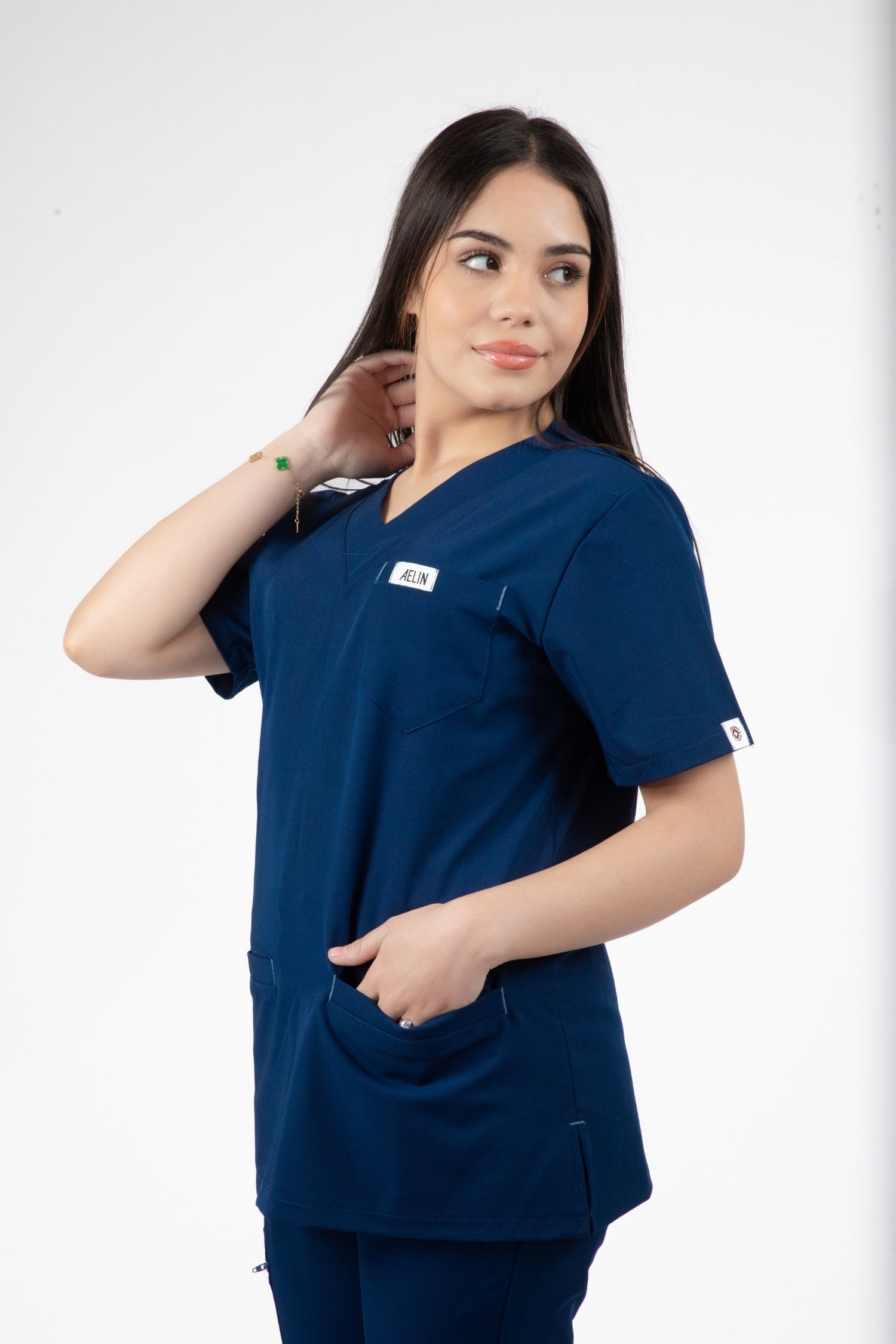 Une femme en uniforme médical bleu Slimfit NEW comprenant une blouse et un pantalon